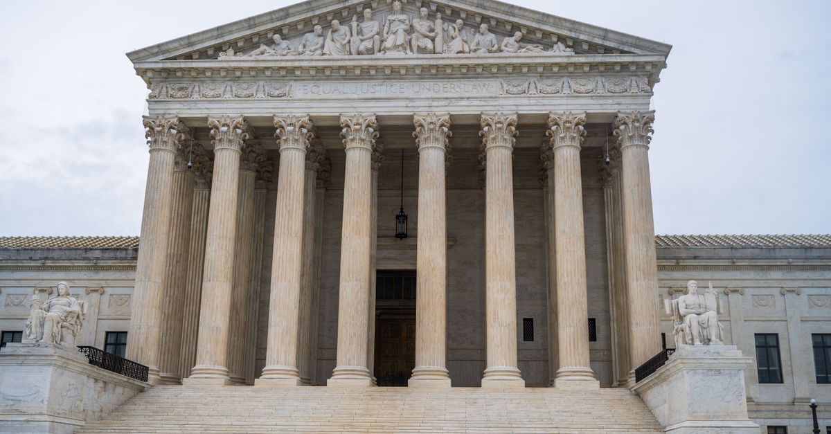 Front view of the iconic US Supreme Court building showcasing its grand columns and classic architecture.
